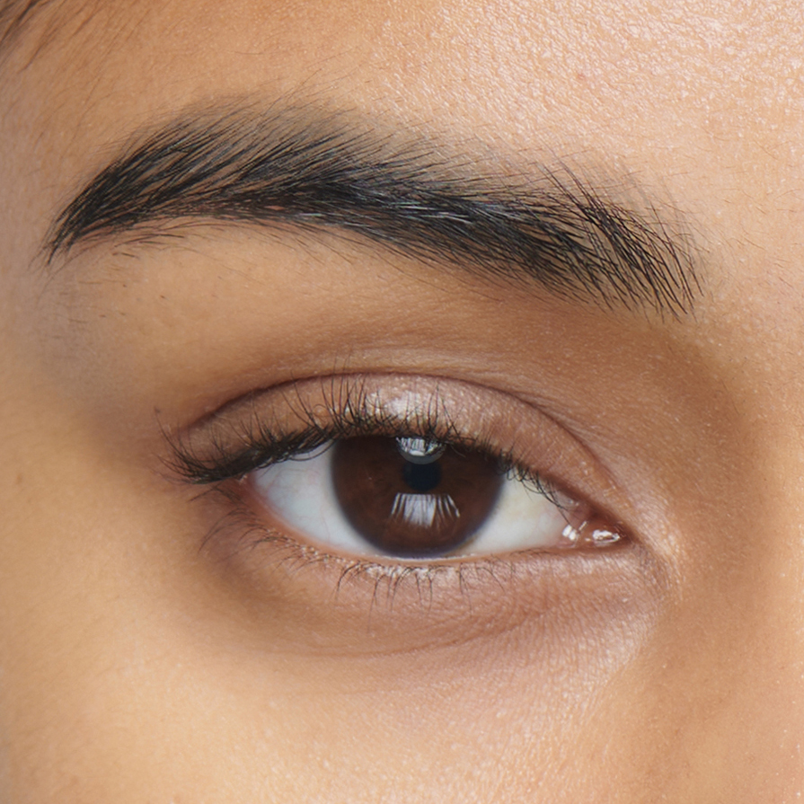 A close-up of a woman's eyebrow before treatment